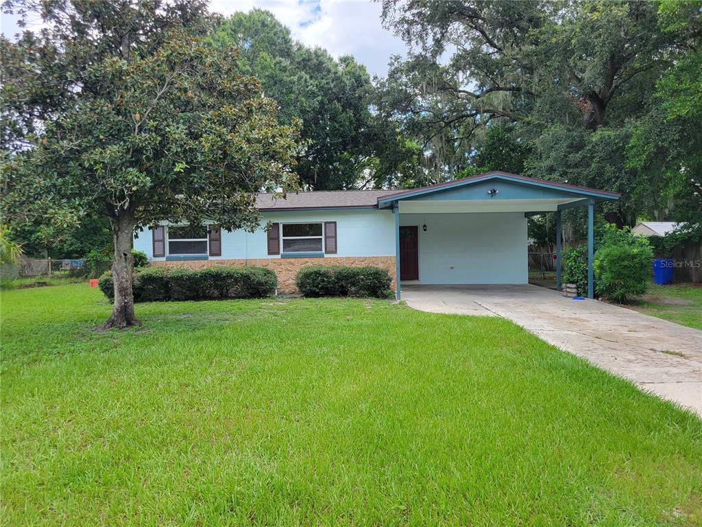 a front view of house with yard and green space