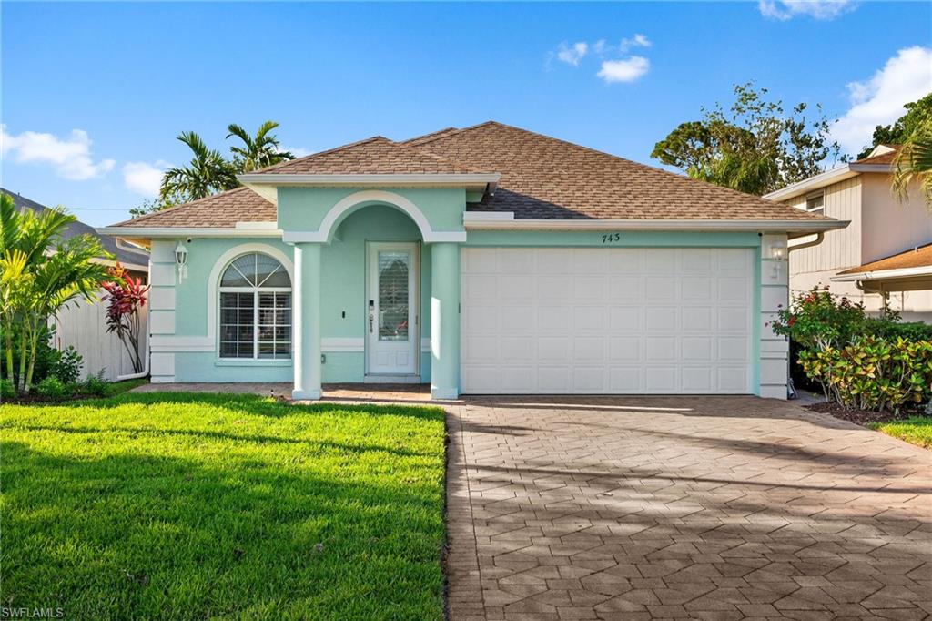 a front view of a house with a yard and garage