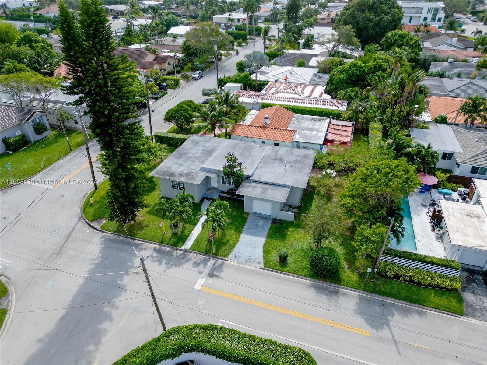 an aerial view of a house with a yard and greenery