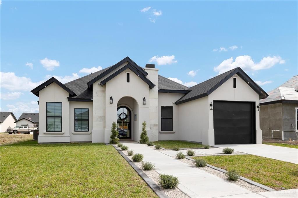 a front view of a house with a yard