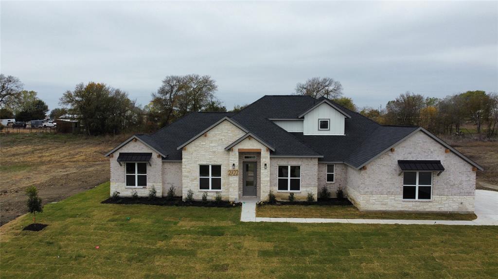 a front view of a house with a yard