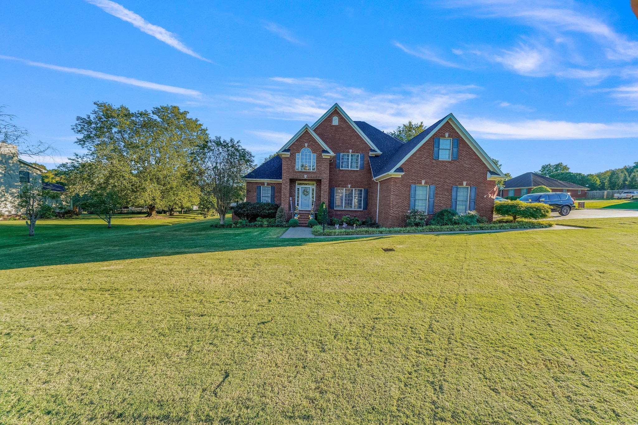 a front view of house with yard and lake view