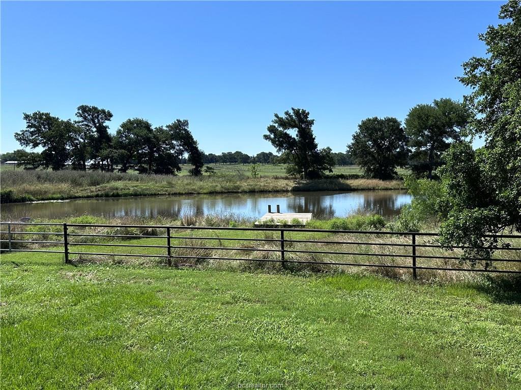 a view of a lake with a bench in the background