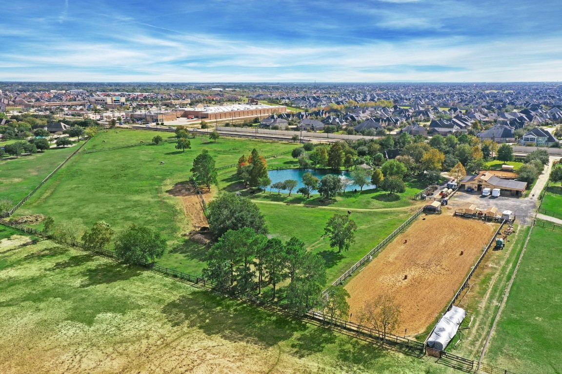 an aerial view of a residential houses with outdoor space and garden