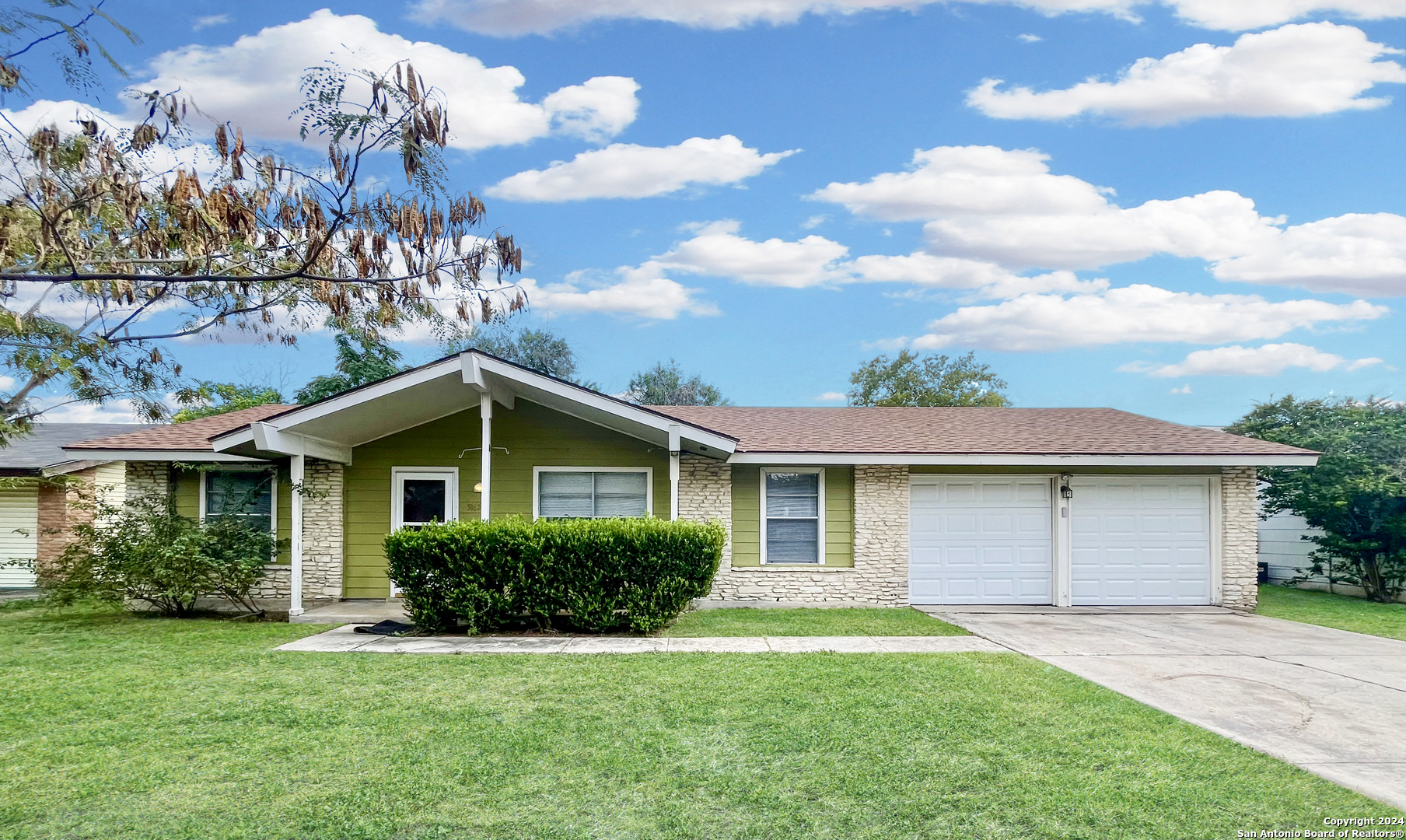 a front view of a house with a garden