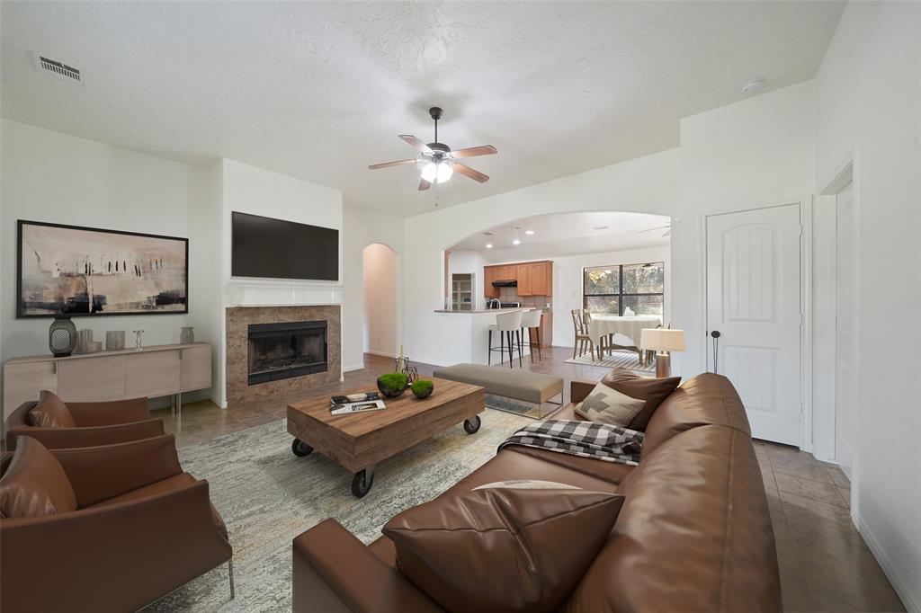 a living room with furniture fireplace and a flat screen tv