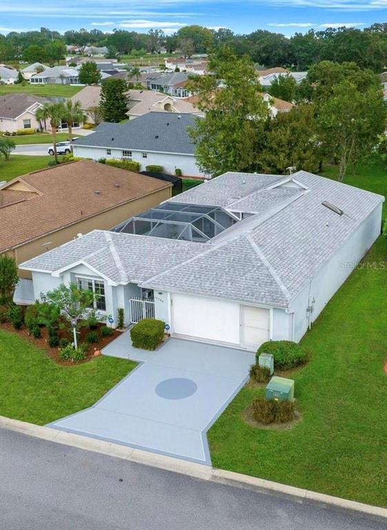 an aerial view of a house with garden space and street view