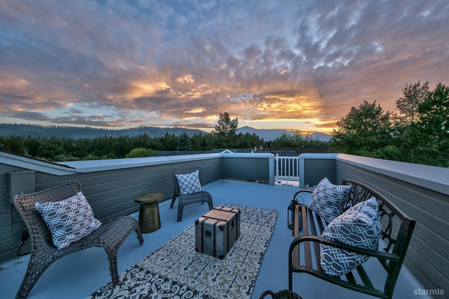 a balcony with wooden floor and outdoor seating