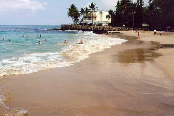 Magic Sands Beach next door. South end of condo complex houses Magic's Beach Grill seen in the background.