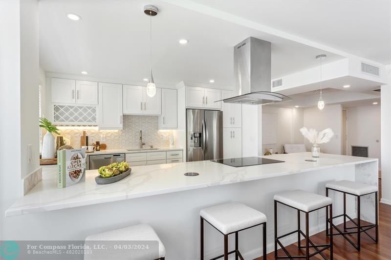 a kitchen with a sink and chairs