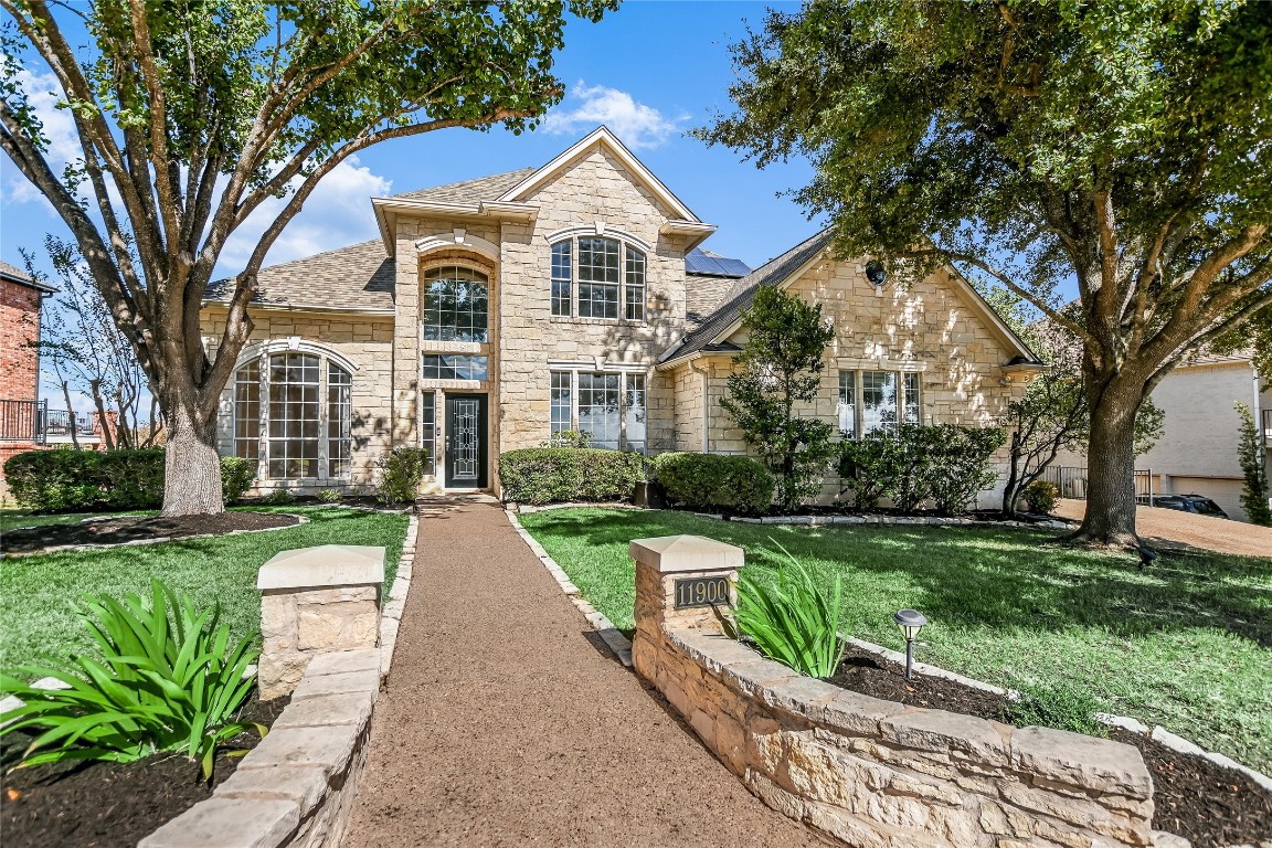 a view of a brick house with a yard