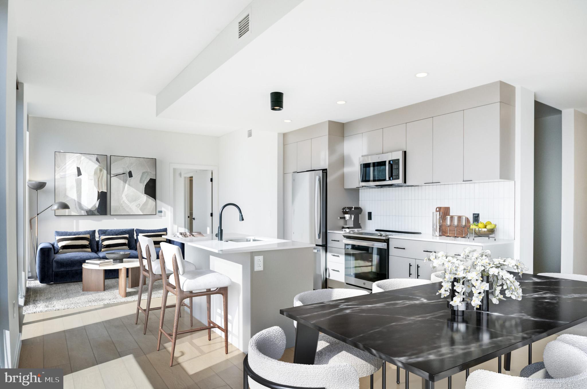 a kitchen with stainless steel appliances a dining table and chairs