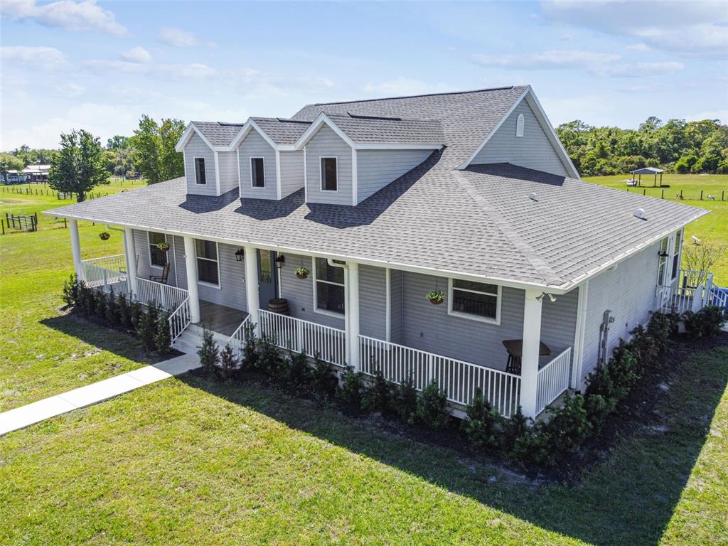 a front view of a house with yard porch and green space