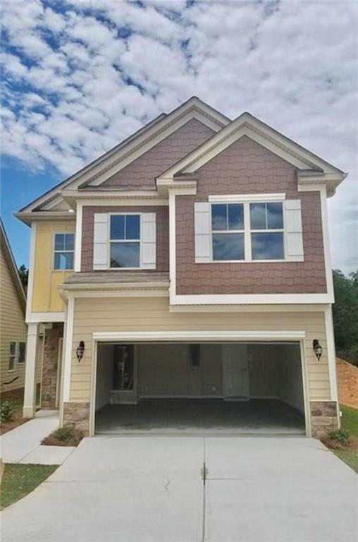 a front view of a house with garage