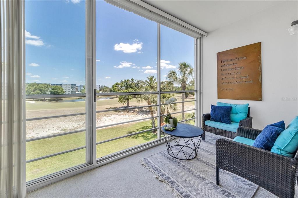 a living room with furniture and a floor to ceiling window