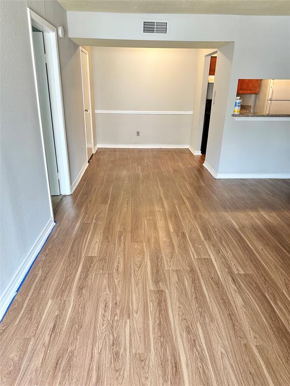 a view of a room with wooden floor and gate