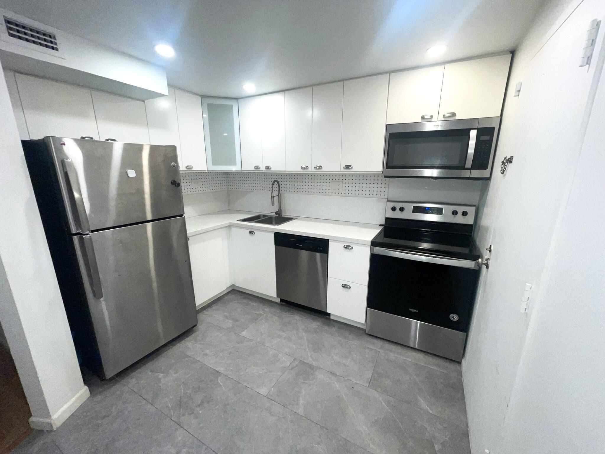 a kitchen with stainless steel appliances a refrigerator stove and microwave