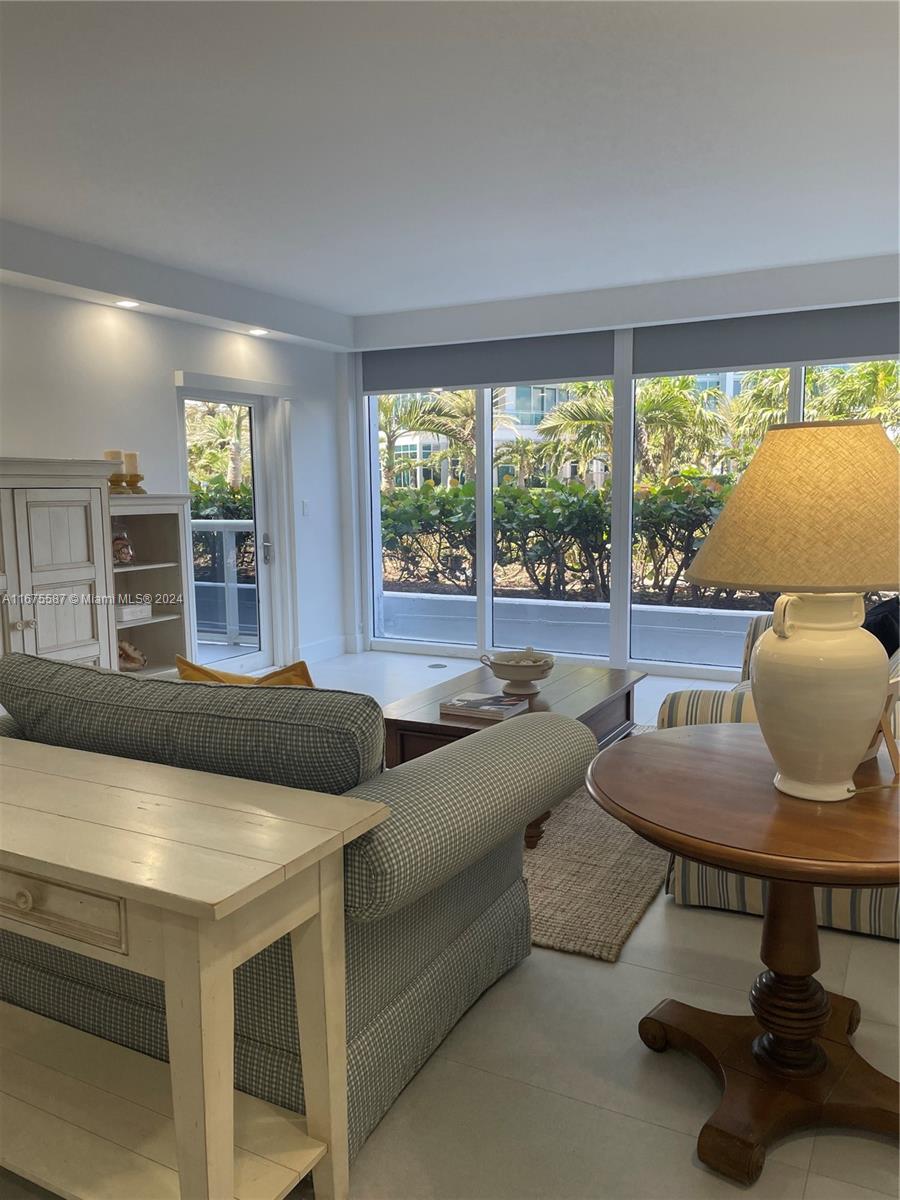 a living room with furniture and a floor to ceiling window