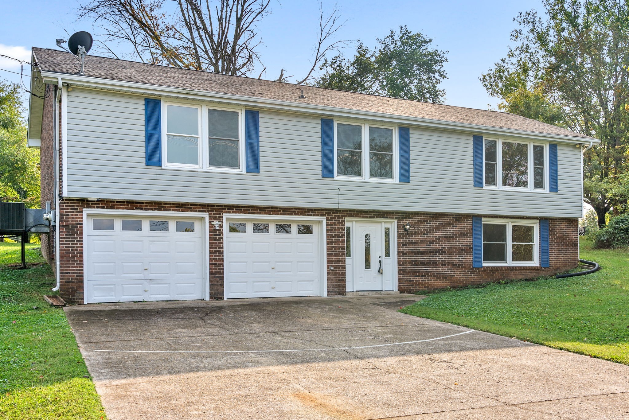 a view of a house with a yard and garage