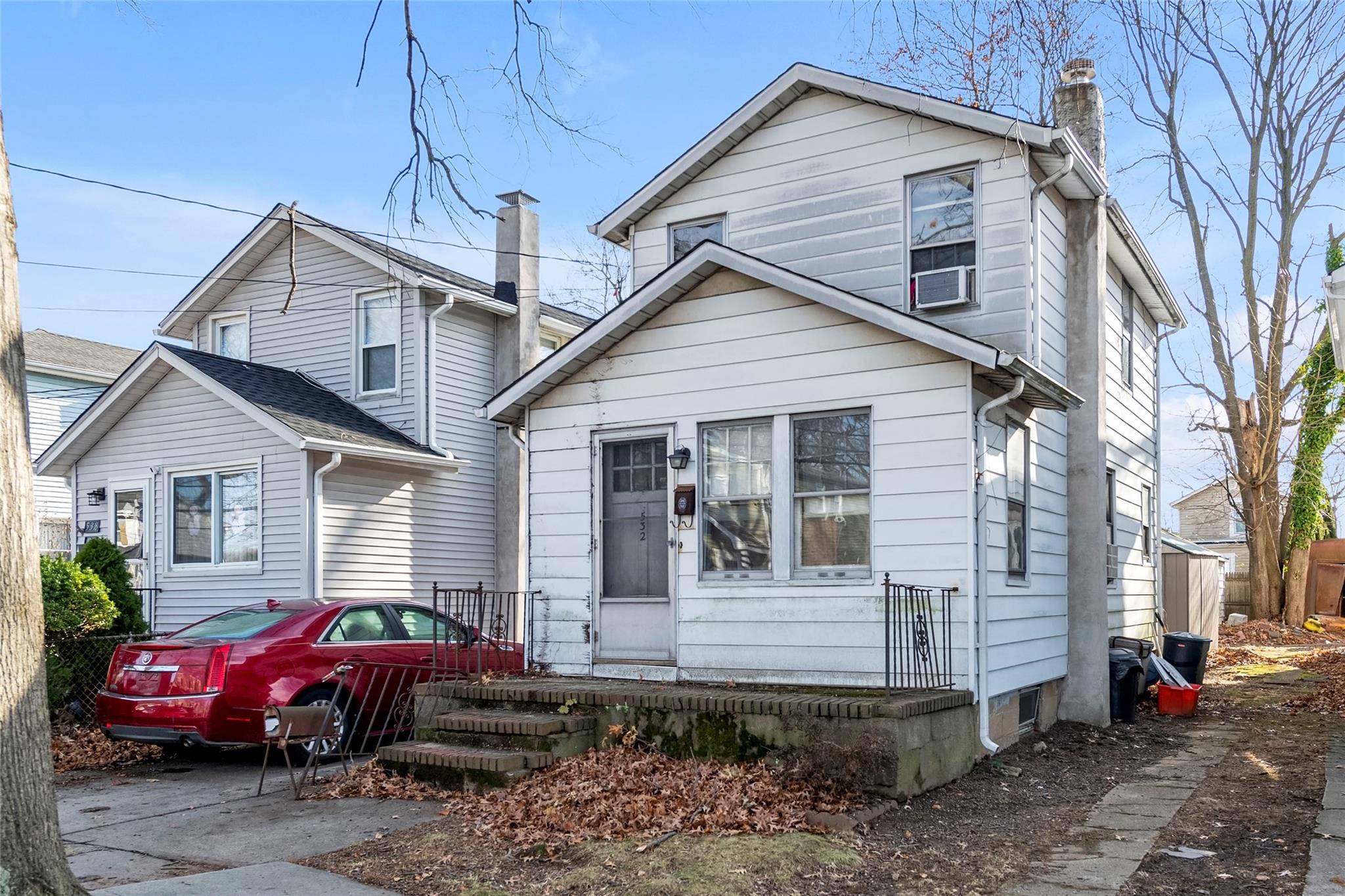 a front view of a house with cars