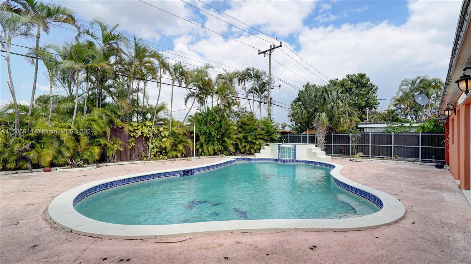 a view of a swimming pool with a yard