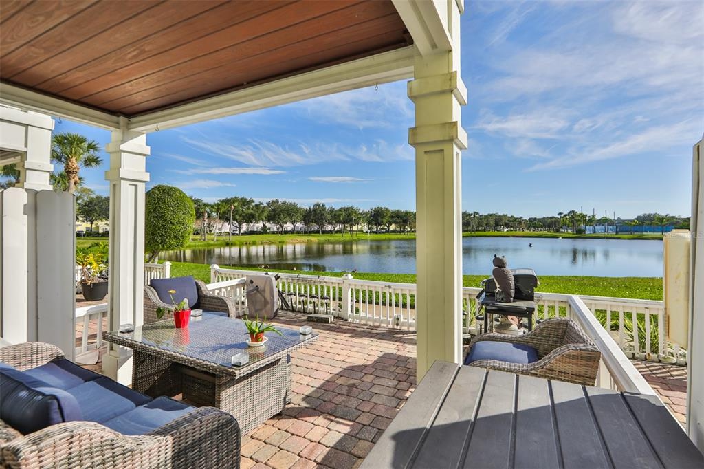 a balcony with wooden floor and outdoor seating