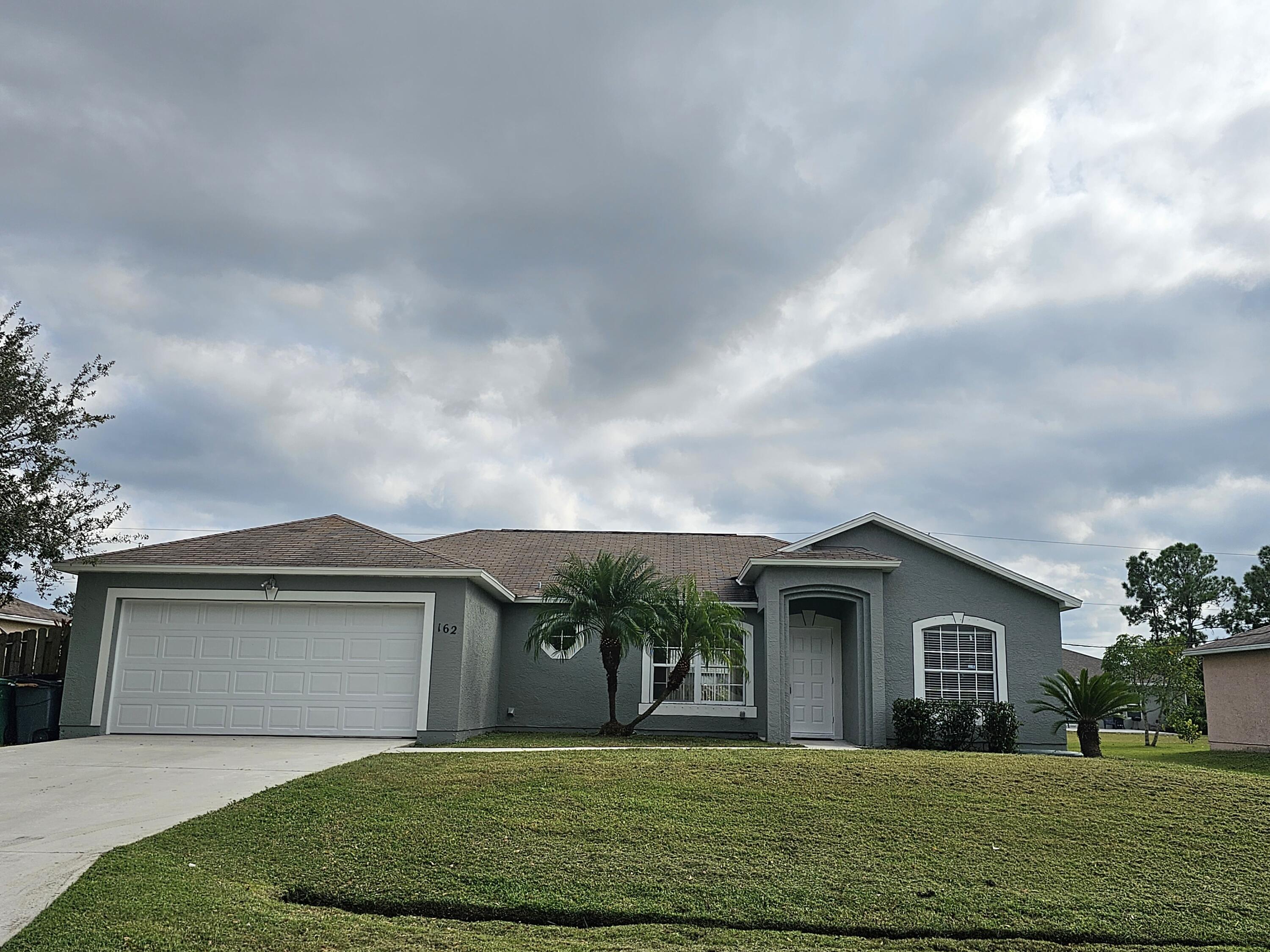 a front view of a house with a yard