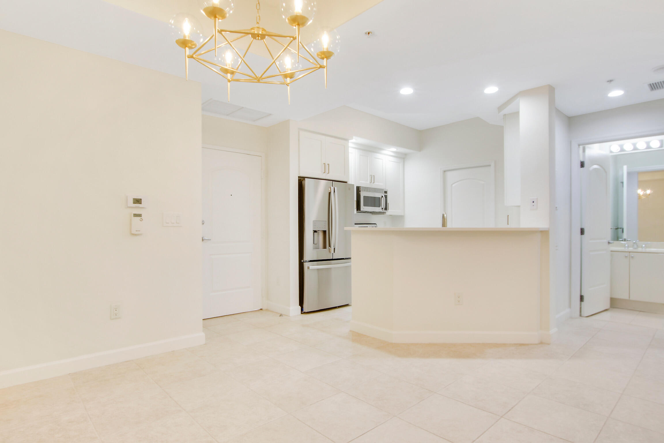 a view of a kitchen with a sink and refrigerator