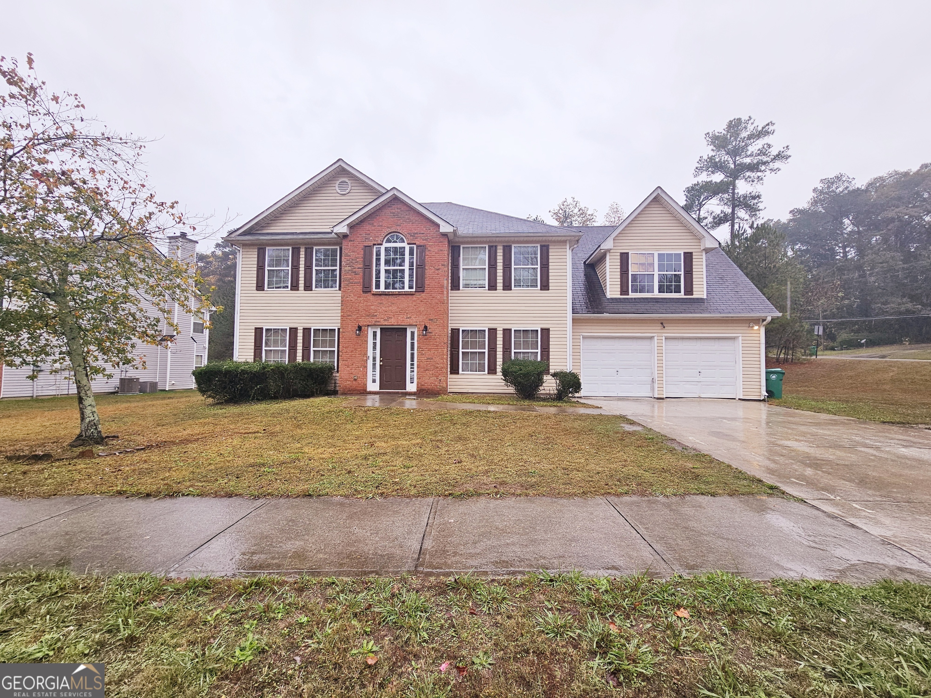 a front view of a house with a yard and garage