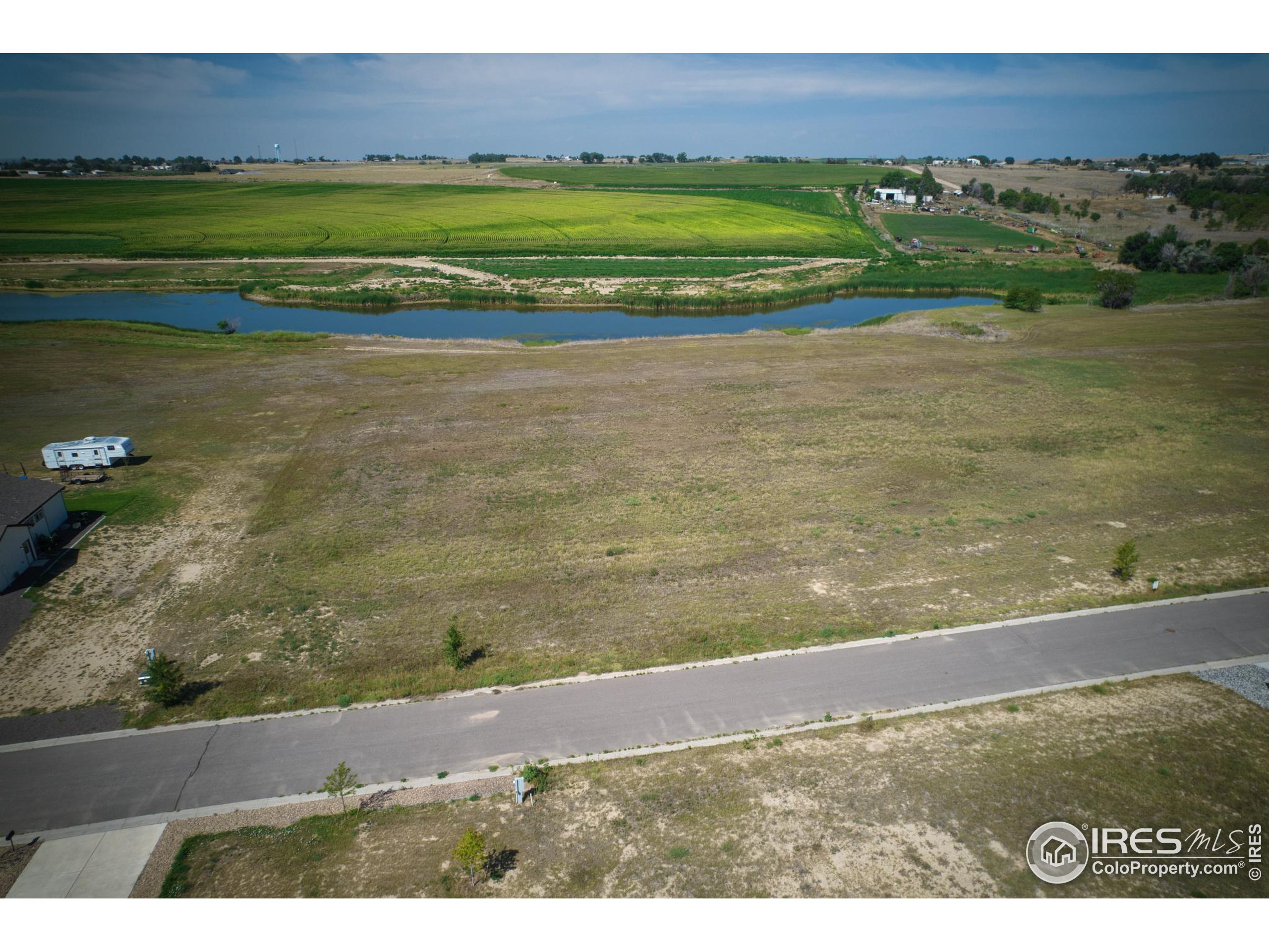 a view of a field with an ocean