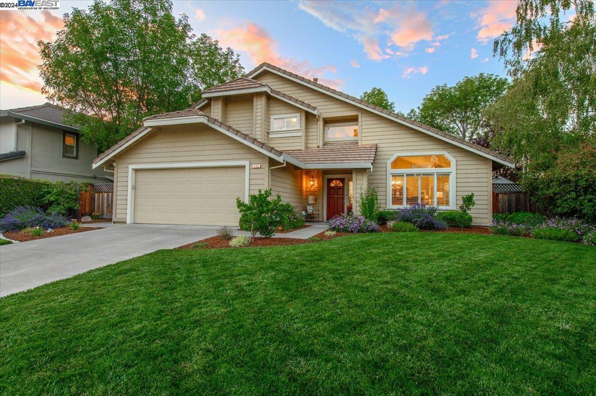 a front view of a house with a yard and garage