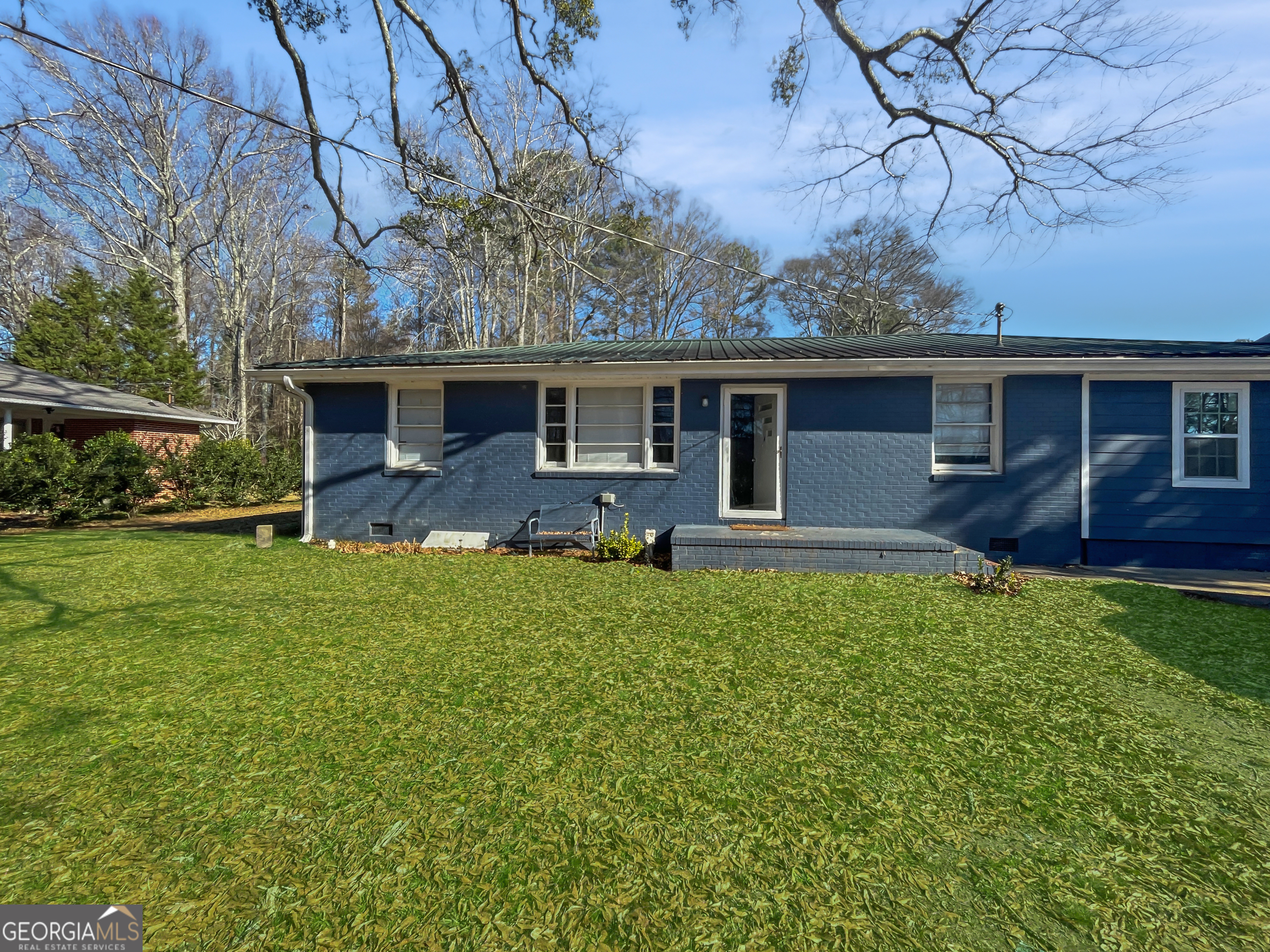 a front view of house with yard and green space