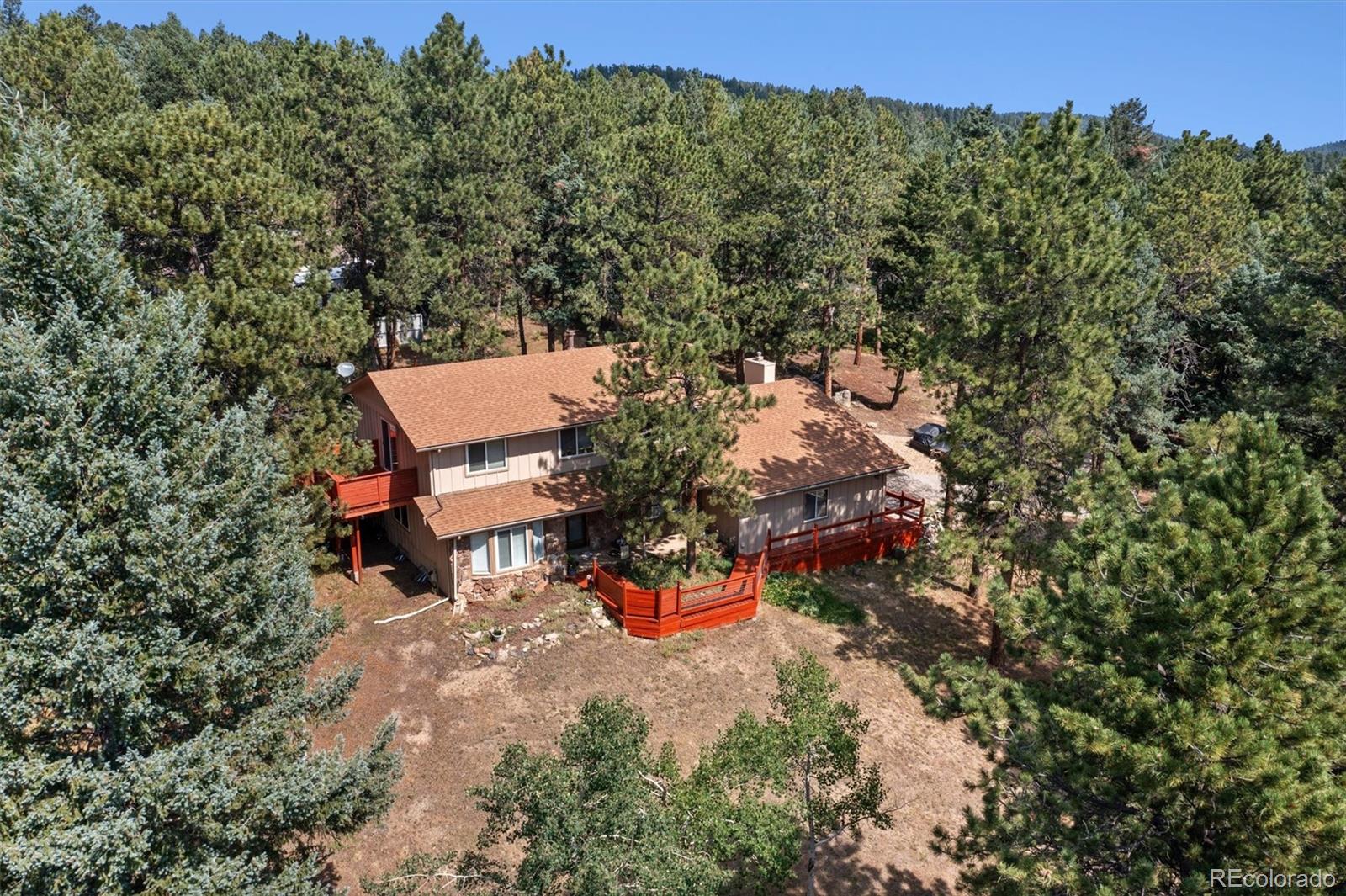 an aerial view of a house with yard and outdoor seating