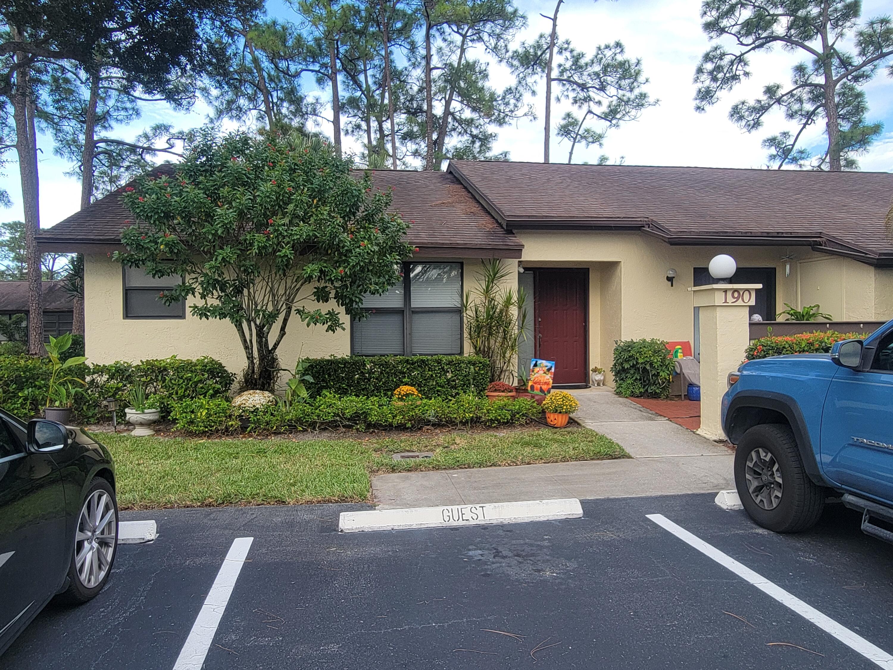 a front view of a house with a garden and plants