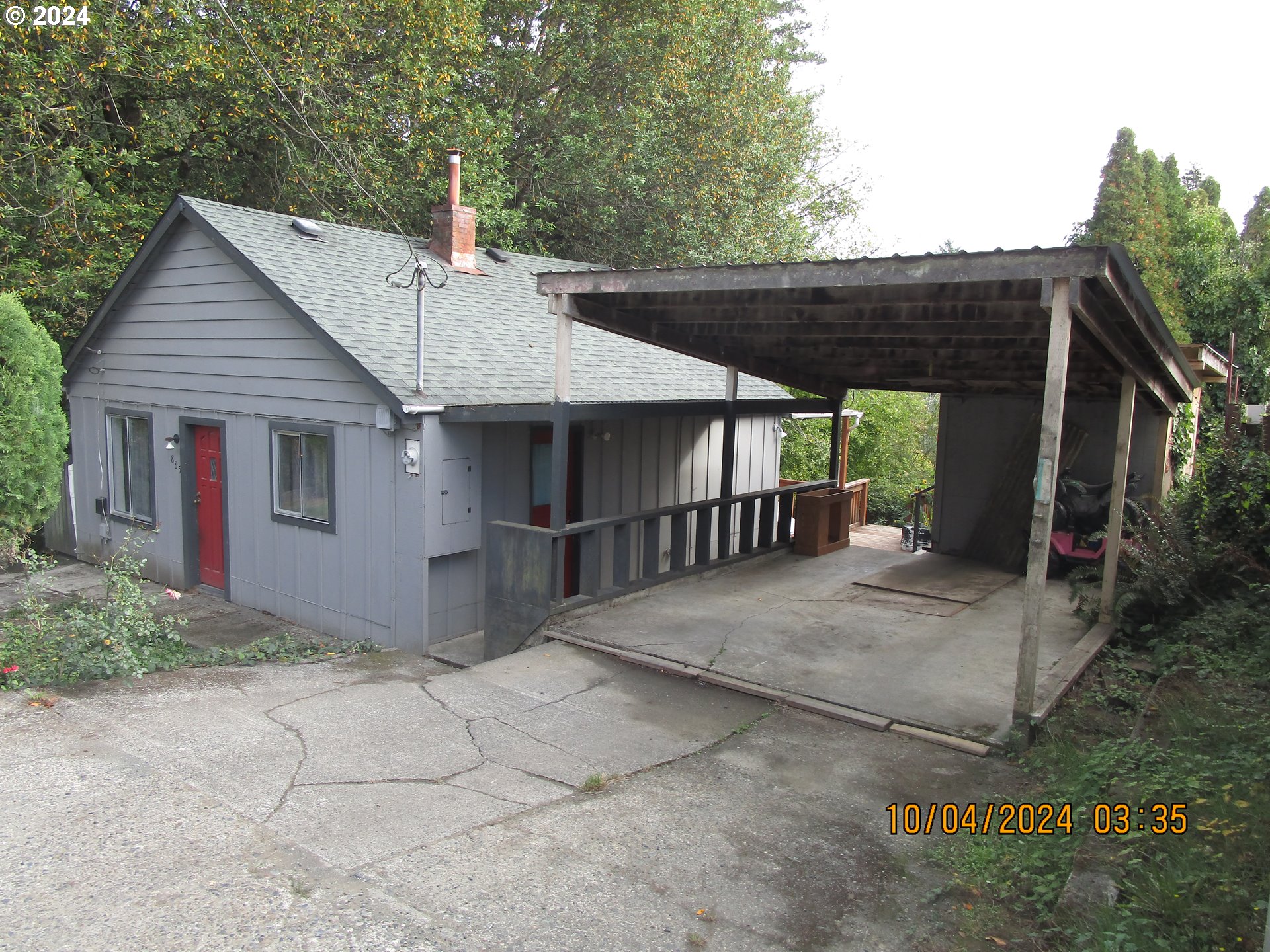 a view of a house with a small yard and wooden fence