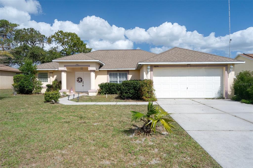 a front view of a house with a yard and garage