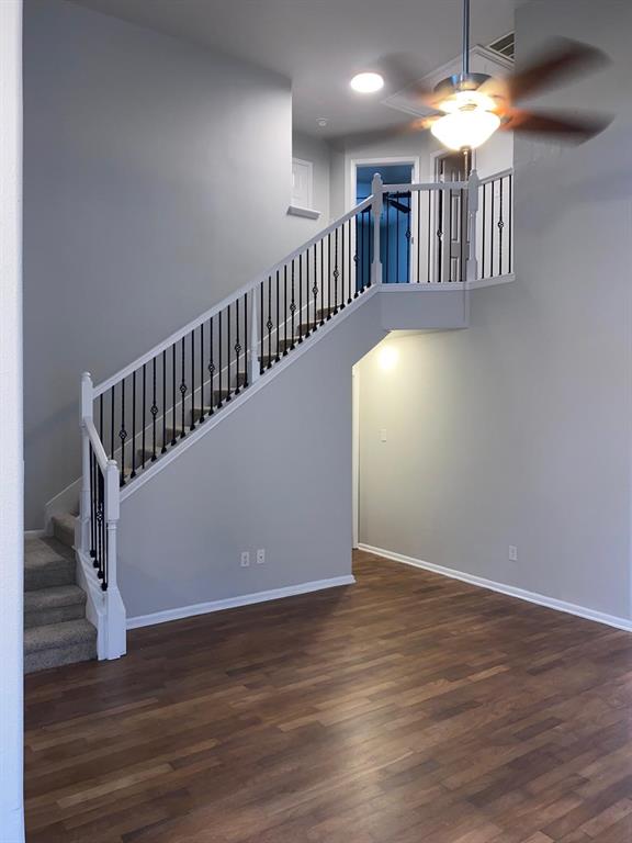 a view of staircase with wooden floor and a chandelier