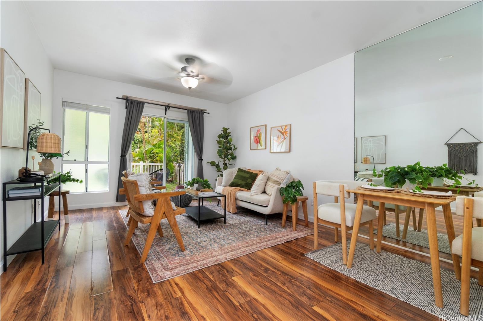 a living room with furniture and a wooden floor