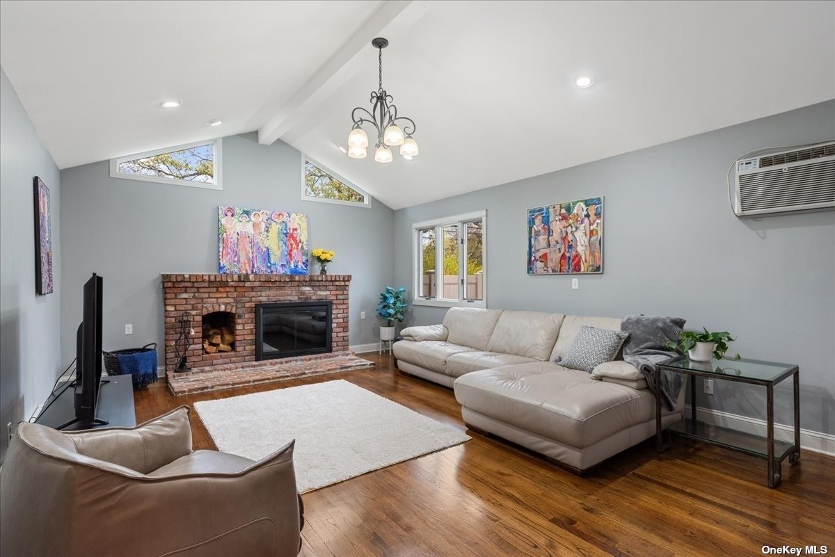 a living room with furniture a fireplace and a chandelier