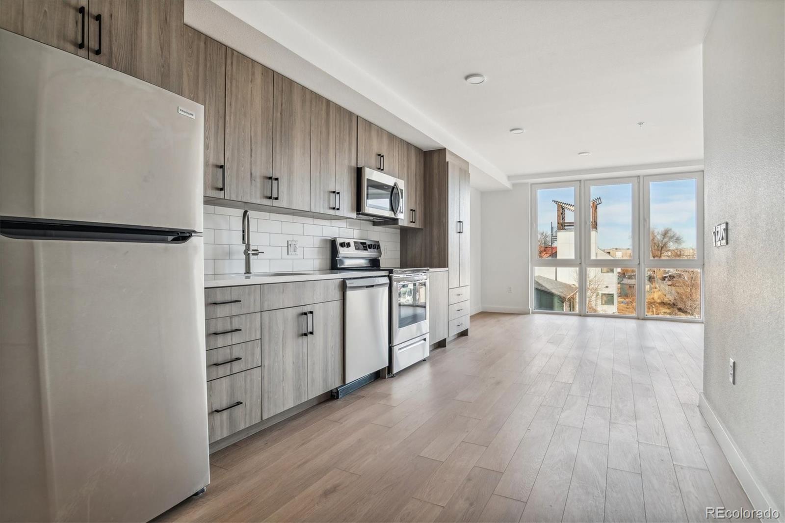 a kitchen with stainless steel appliances a refrigerator sink and cabinets