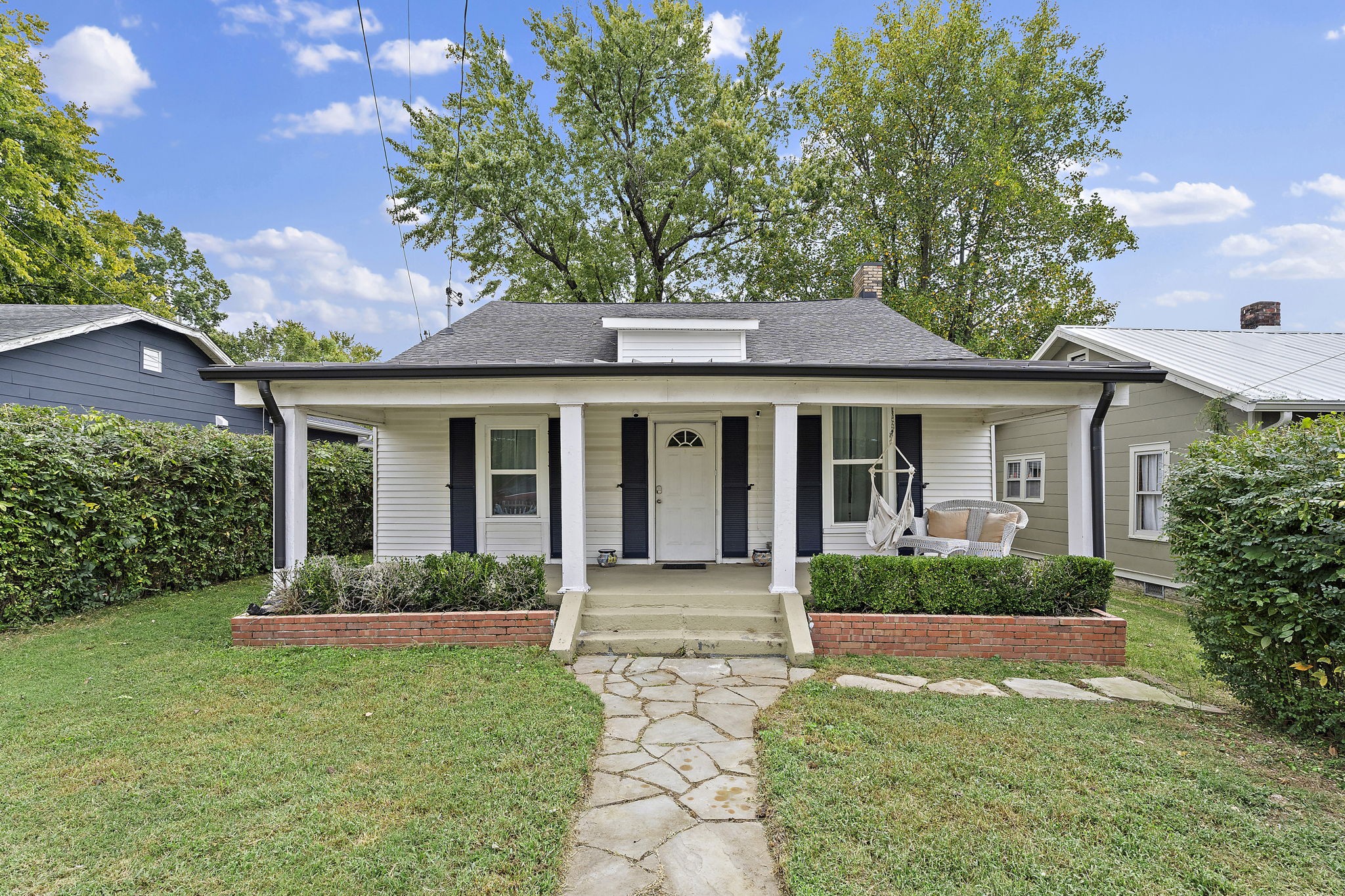 a front view of a house with garden