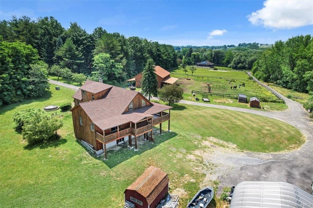 an aerial view of a house with garden space and street view