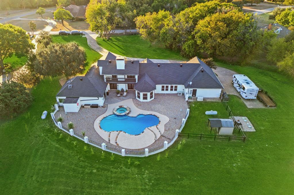 a aerial view of a house with backyard and pool