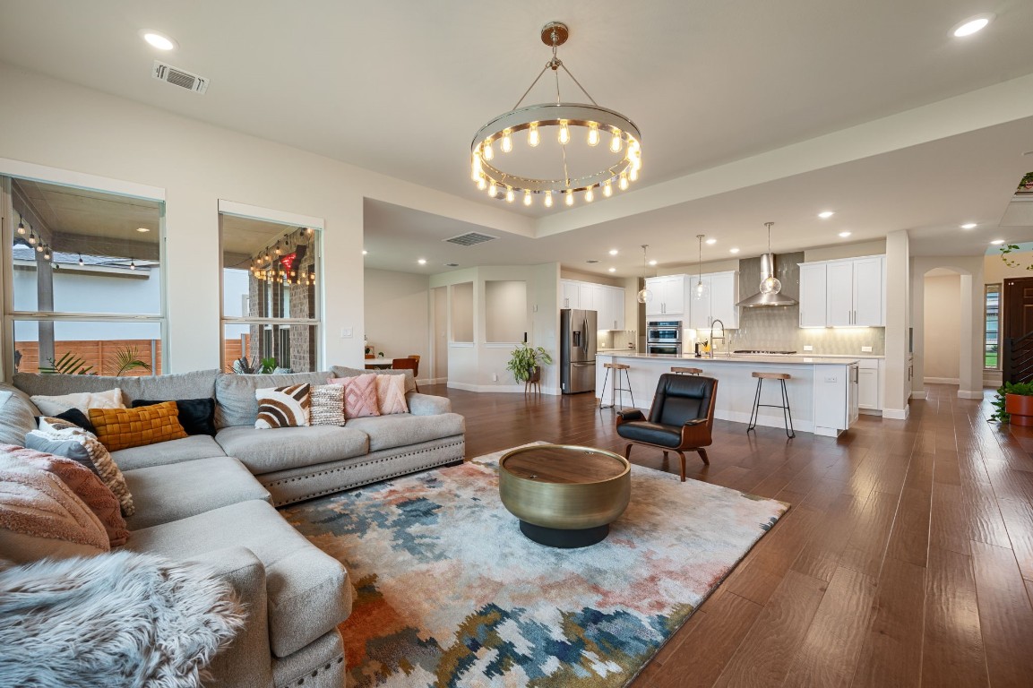 a living room with furniture and a view of kitchen