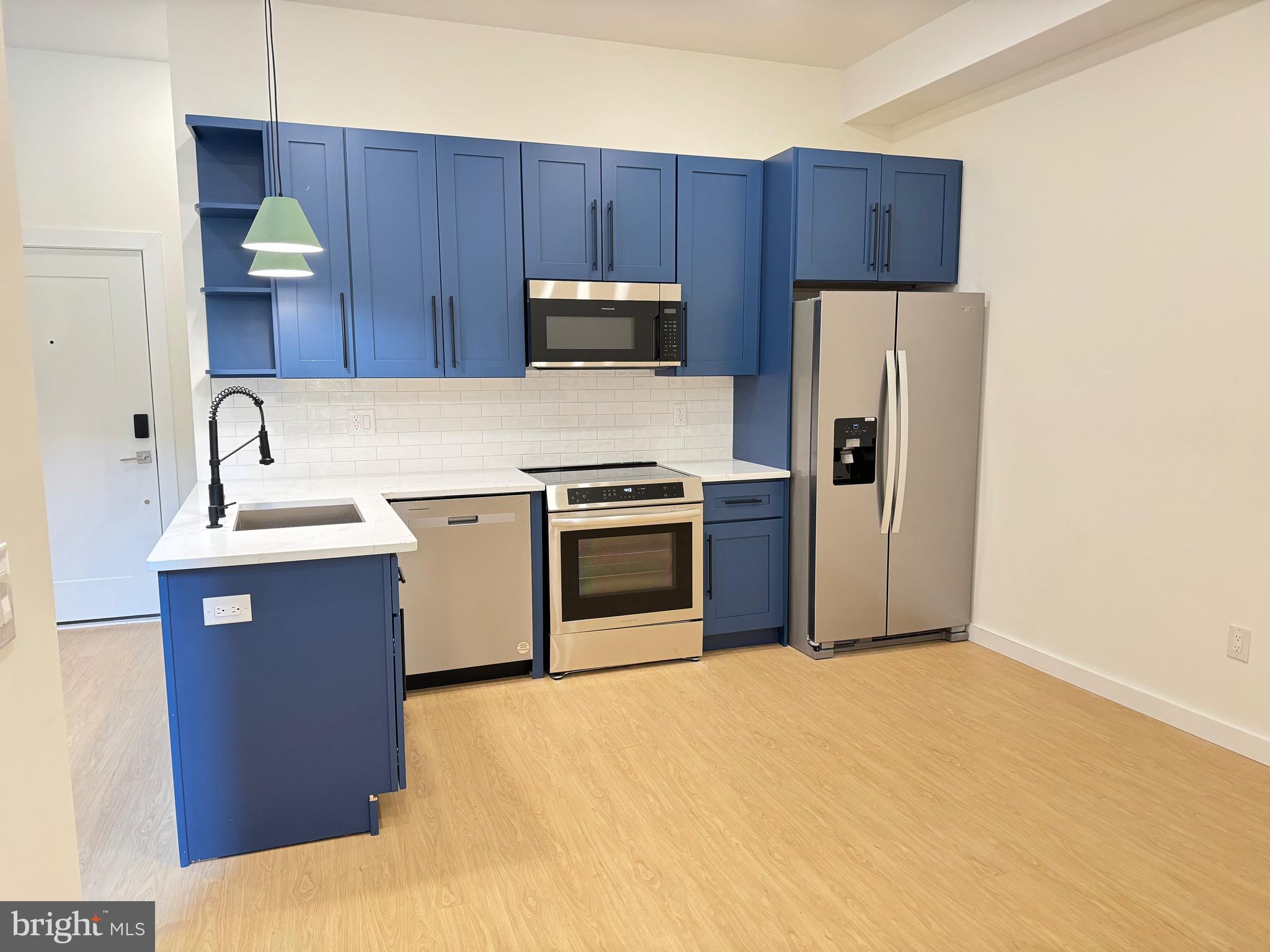 a kitchen with a sink a stove and refrigerator