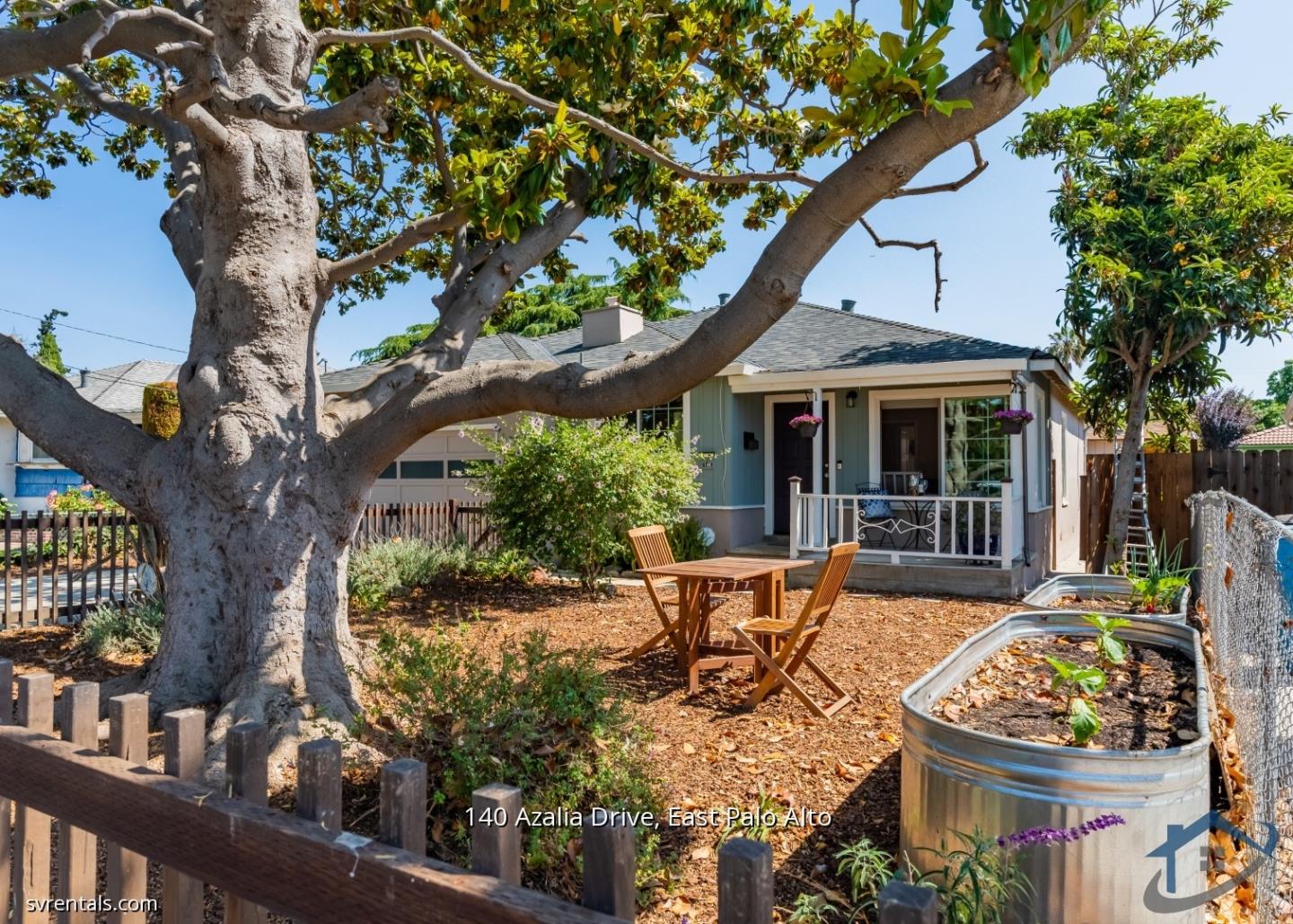 a view of an house with backyard space and sitting area