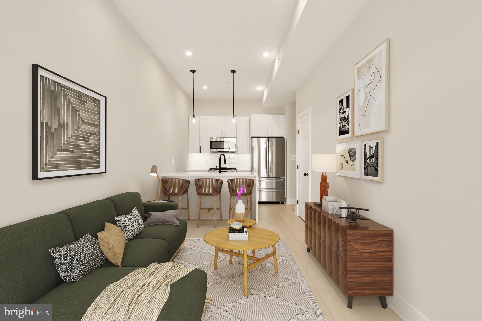 a living room with furniture and kitchen view