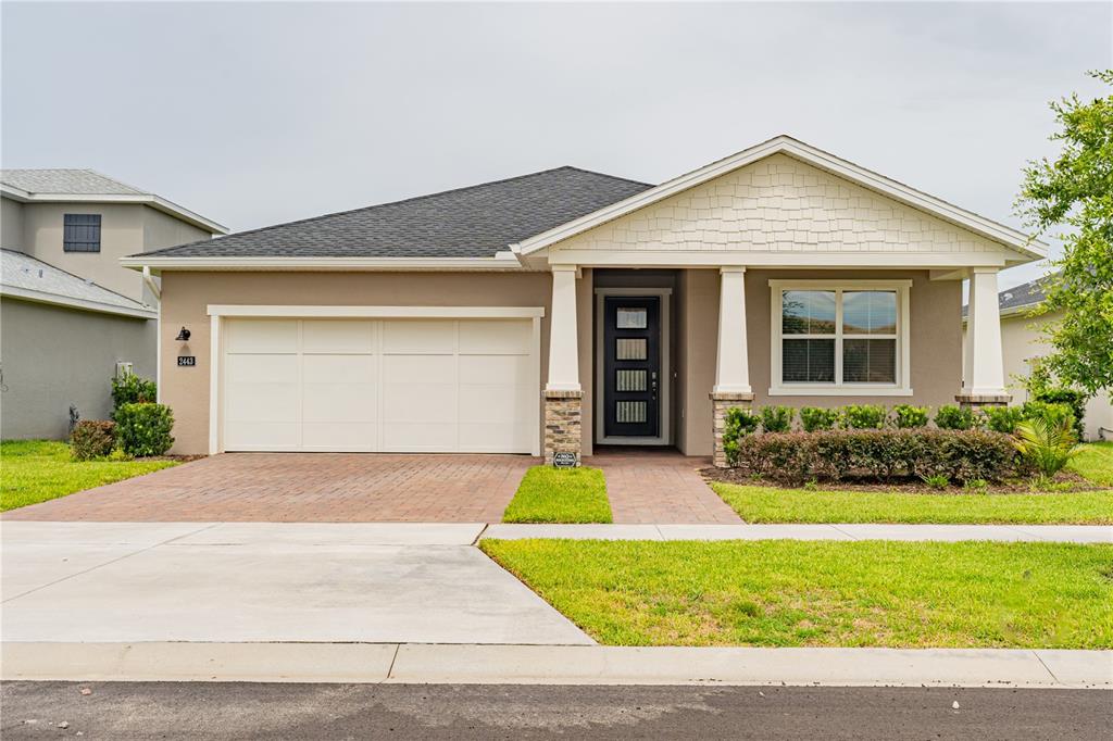 a front view of a house with a yard and garage