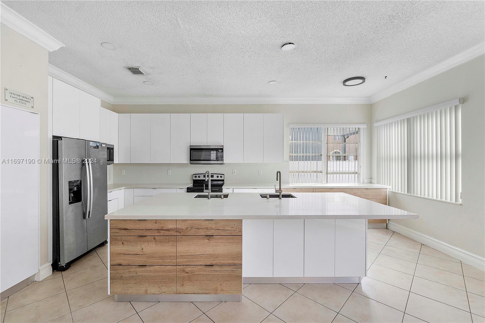 a kitchen with a refrigerator and a sink