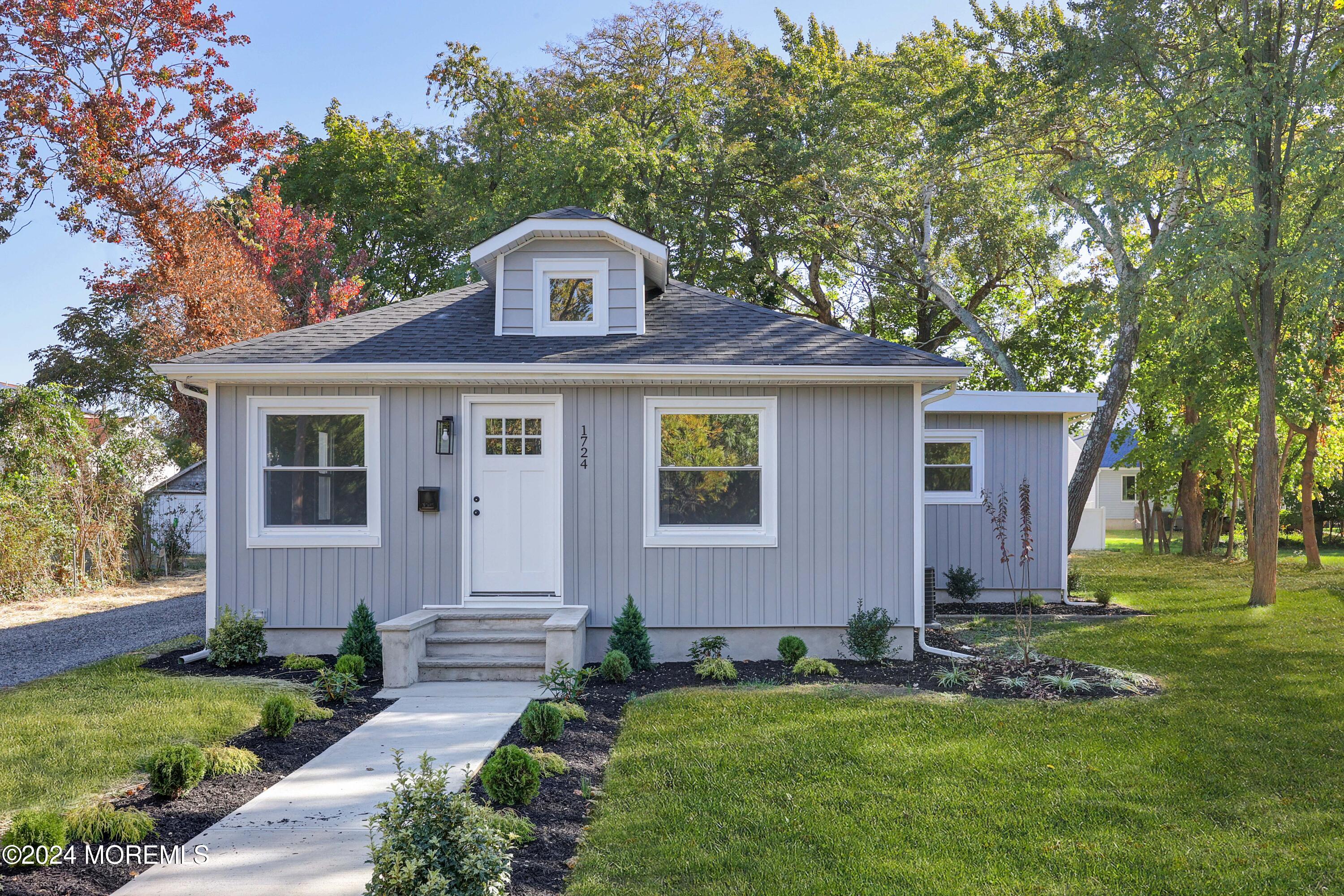 a front view of a house with a garden